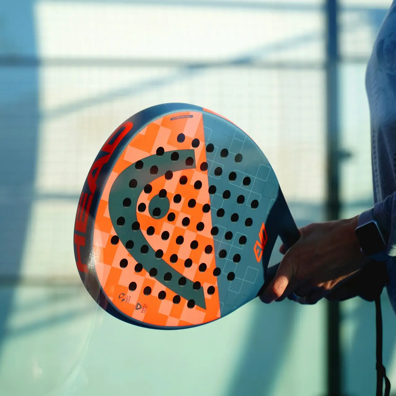 person holding orange and white polka dot round ball